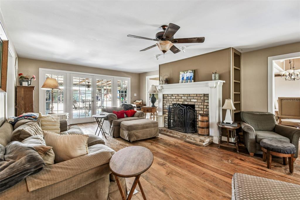 15019 Carlton Lake Road Wimauma, FL 33598 - Photo 21 of 89 a living room with furniture and a fireplace