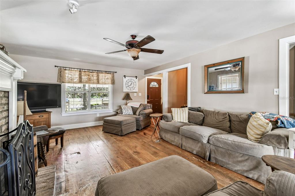 15019 Carlton Lake Road Wimauma, FL 33598 - Photo 24 of 89 a living room with furniture and a flat screen tv