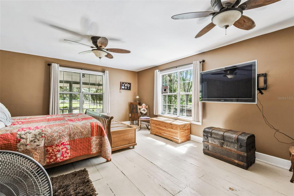 15019 Carlton Lake Road Wimauma, FL 33598 - Photo 27 of 89 a bedroom with a bed flat screen tv and a window