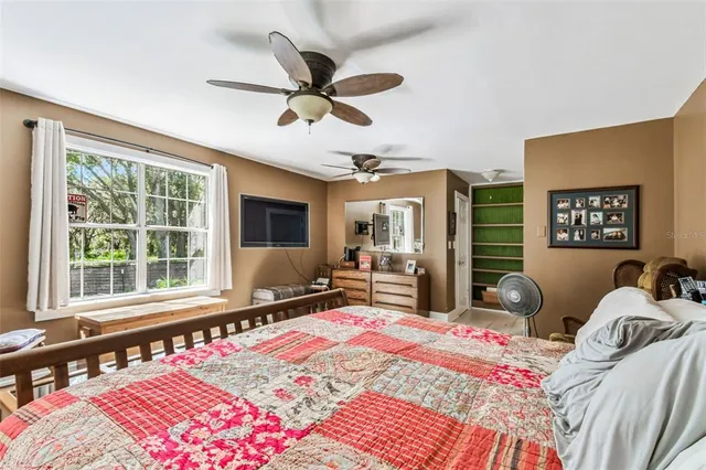 a bedroom with a bed and dresser with mirror