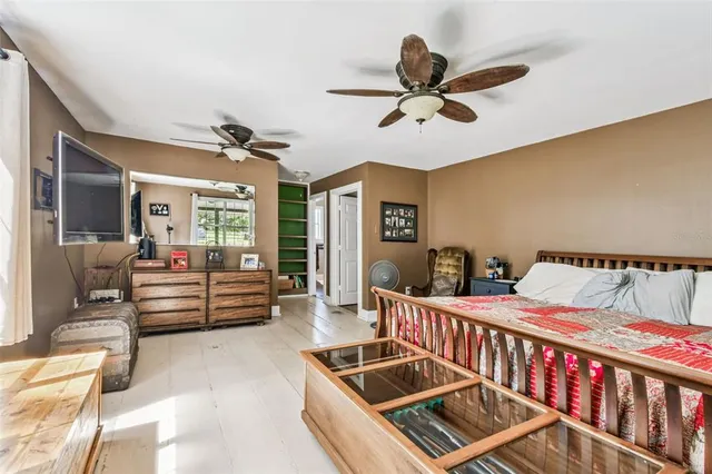 a bedroom with a large bed and a chandelier