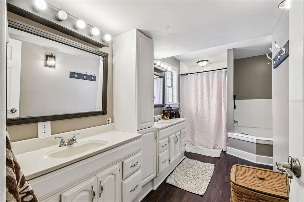 15019 Carlton Lake Road Wimauma, FL 33598 - Photo 32 of 89 a bathroom with double vanity sink and mirror