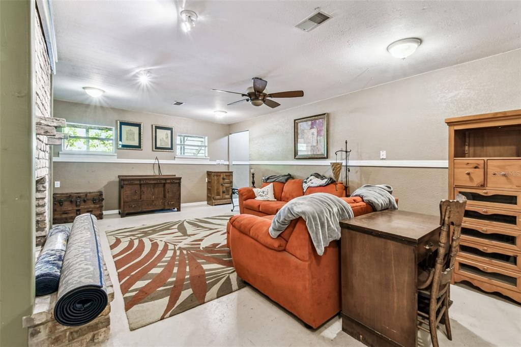 15019 Carlton Lake Road Wimauma, FL 33598 - Photo 36 of 89 a bedroom with furniture and a fireplace