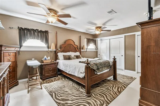 a view of a house with a big yard and large trees