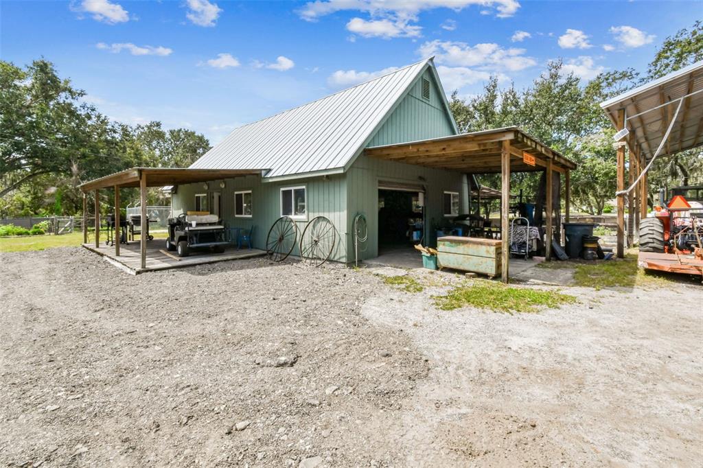 15019 Carlton Lake Road Wimauma, FL 33598 - Photo 47 of 89 a view of a house with a patio and a yard