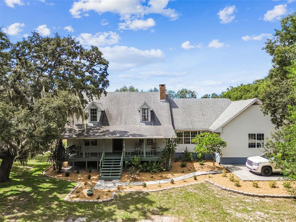 15019 Carlton Lake Road Wimauma, FL 33598 - Photo 5 of 89 a view of a house with backyard sitting area and garden