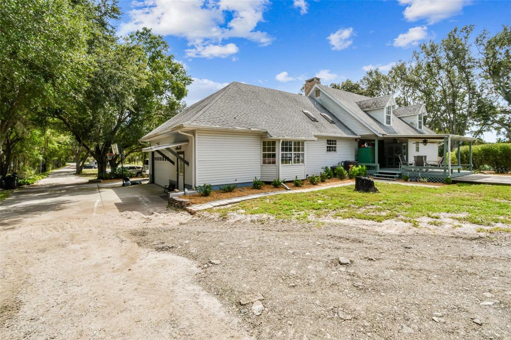 15019 Carlton Lake Road Wimauma, FL 33598 - Photo 62 of 89 a view of a house with a big yard and large trees