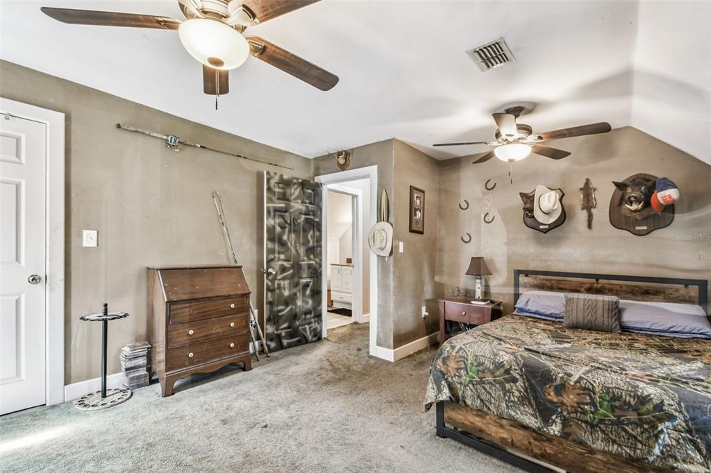 15019 Carlton Lake Road Wimauma, FL 33598 - Photo 72 of 89 a bedroom with a bed and ceiling fan
