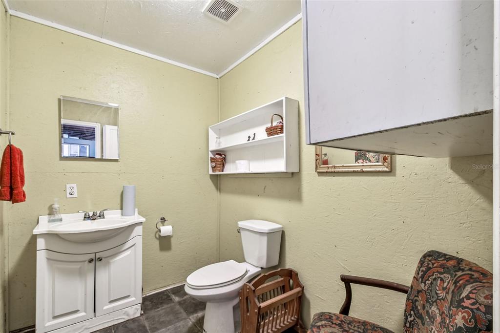 15019 Carlton Lake Road Wimauma, FL 33598 - Photo 82 of 89 a bathroom with a toilet a sink and mirror