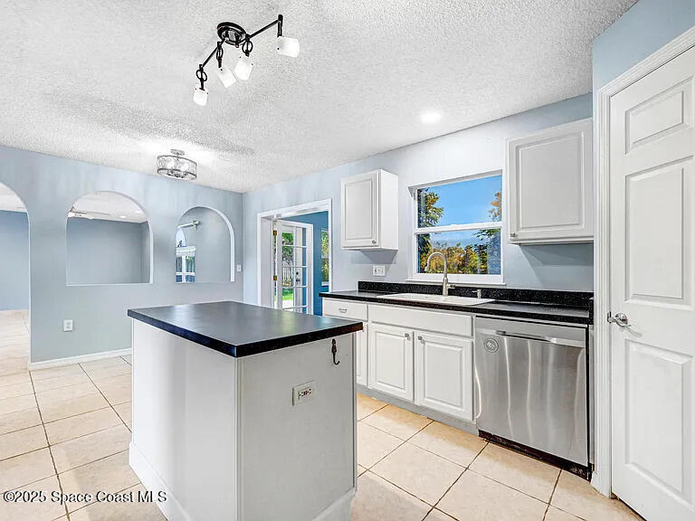 2240 Spring Creek Circle Palm Bay, FL 32905 - Photo 12 of 29 a kitchen with a sink stove and cabinets