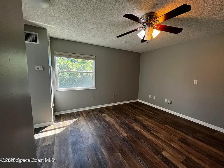 2240 Spring Creek Circle Palm Bay, FL 32905 - Photo 18 of 29 wooden floor in an empty room with a window