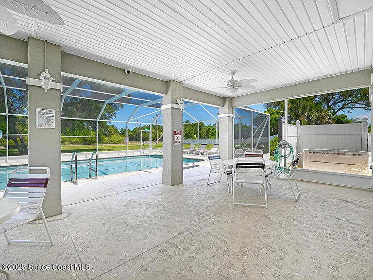 2240 Spring Creek Circle Palm Bay, FL 32905 - Photo 22 of 29 a view of a patio with table and chairs and a barbeque