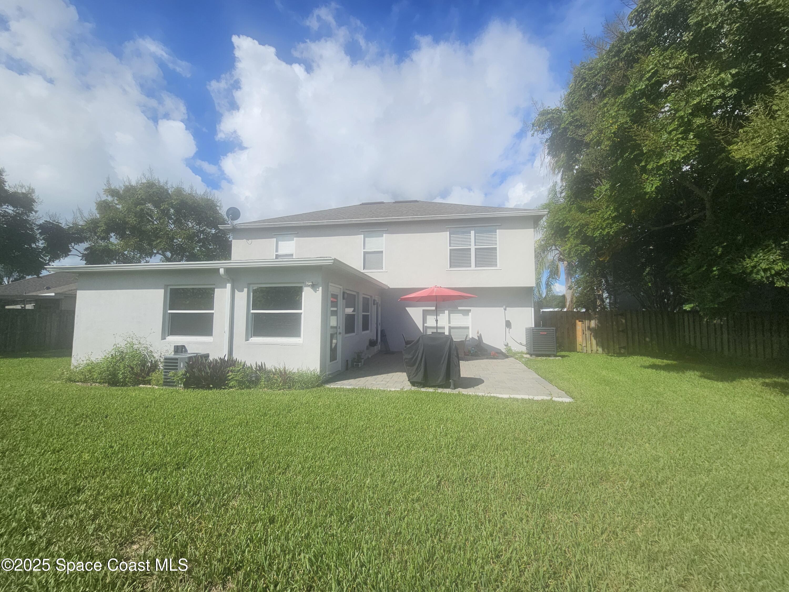 2240 Spring Creek Circle Palm Bay, FL 32905 - Photo 24 of 29 a front view of house with yard and green space