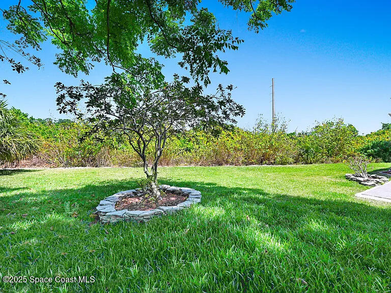 2240 Spring Creek Circle Palm Bay, FL 32905 - Photo 5 of 29 a front view of a house with garden
