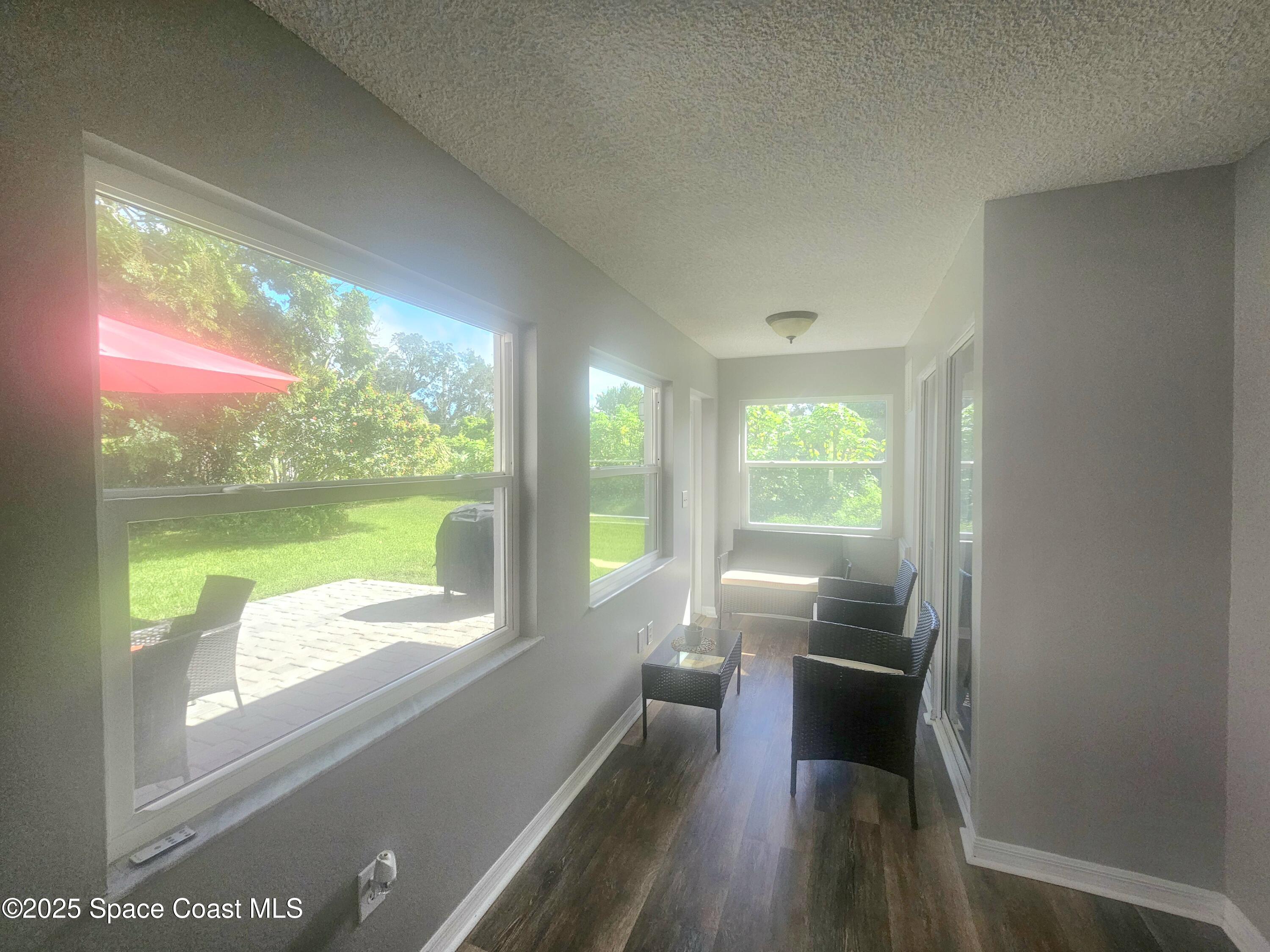 2240 Spring Creek Circle Palm Bay, FL 32905 - Photo 8 of 29 a view of a big room with wooden floor and windows