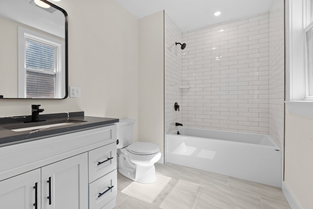 37 George Street, Unit 37 Newton, MA 02458 - Photo 13 of 35 a bathroom with a granite countertop sink a toilet and bathtub