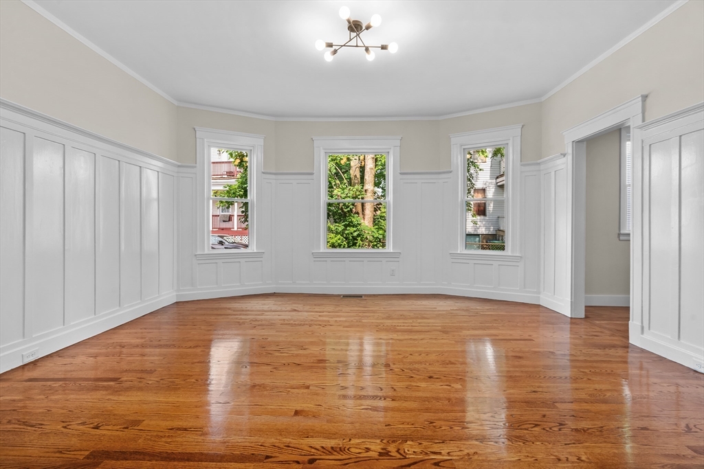 37 George Street, Unit 37 Newton, MA 02458 - Photo 17 of 35 a view of an empty room with window and wooden floor