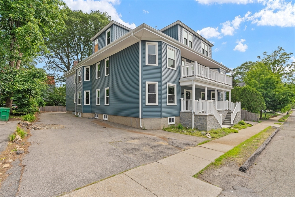 37 George Street, Unit 37 Newton, MA 02458 - Photo 24 of 35 a front view of a house with a garden and trees