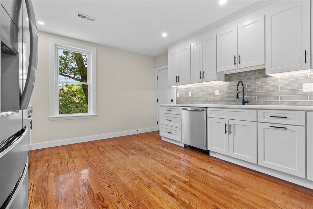 37 George Street, Unit 37 Newton, MA 02458 - Photo 3 of 35 a kitchen with white cabinets and window