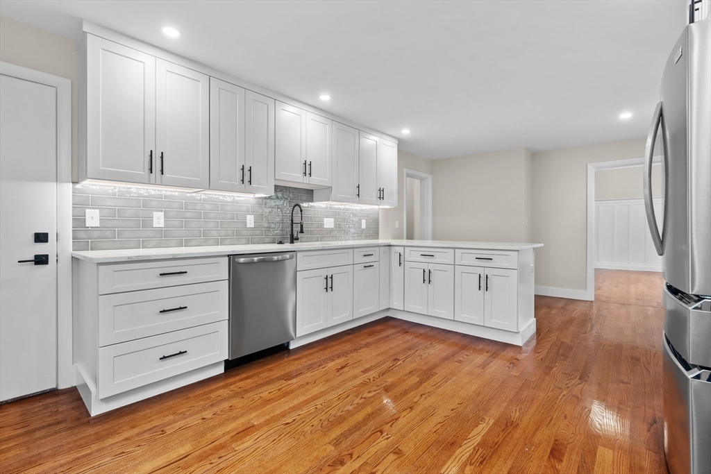 37 George Street, Unit 37 Newton, MA 02458 - Photo 10 of 35 a kitchen with a cabinets stainless steel appliances and wooden floor