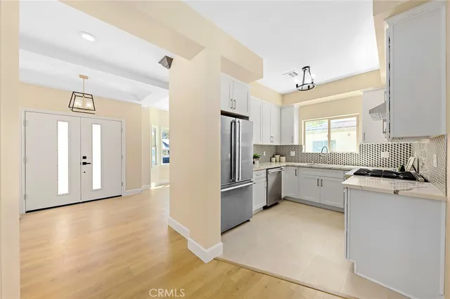 a kitchen with granite countertop a stove sink and cabinets