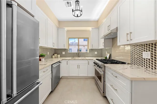 a kitchen with stove and cabinets