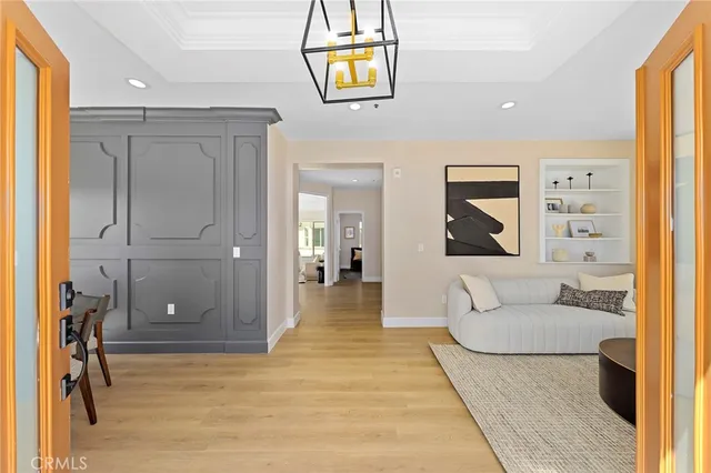 a living room with furniture and large windows