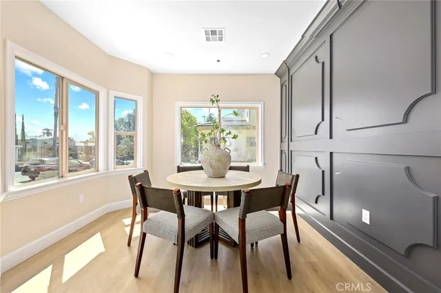 a view of a dining room with furniture and a potted plant