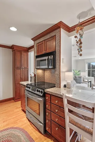 a kitchen with stainless steel appliances granite countertop a stove and a microwave
