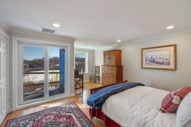 a bedroom with a large bed and a chandelier
