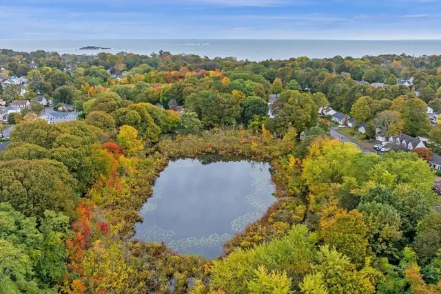 an aerial view of a houses with a yard