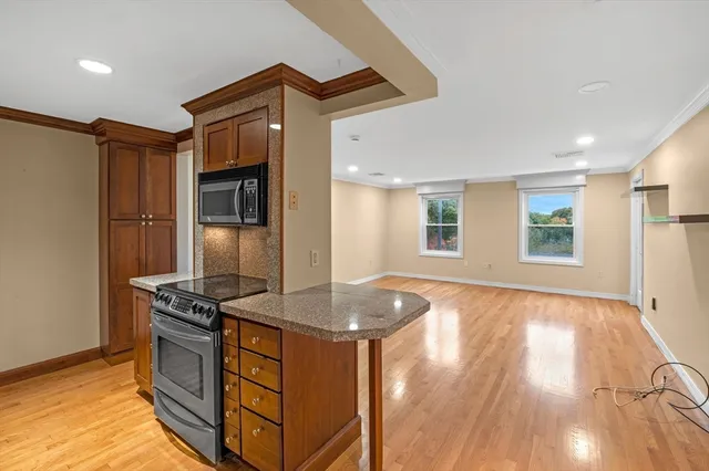 a kitchen with granite countertop a stove and a refrigerator