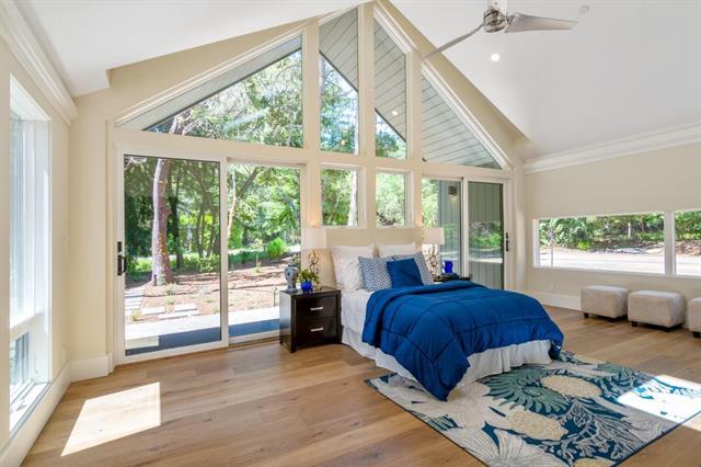 110 Stadler Drive Woodside, CA 94062 - Photo 23 of 27 a bedroom with a bed and wooden floor