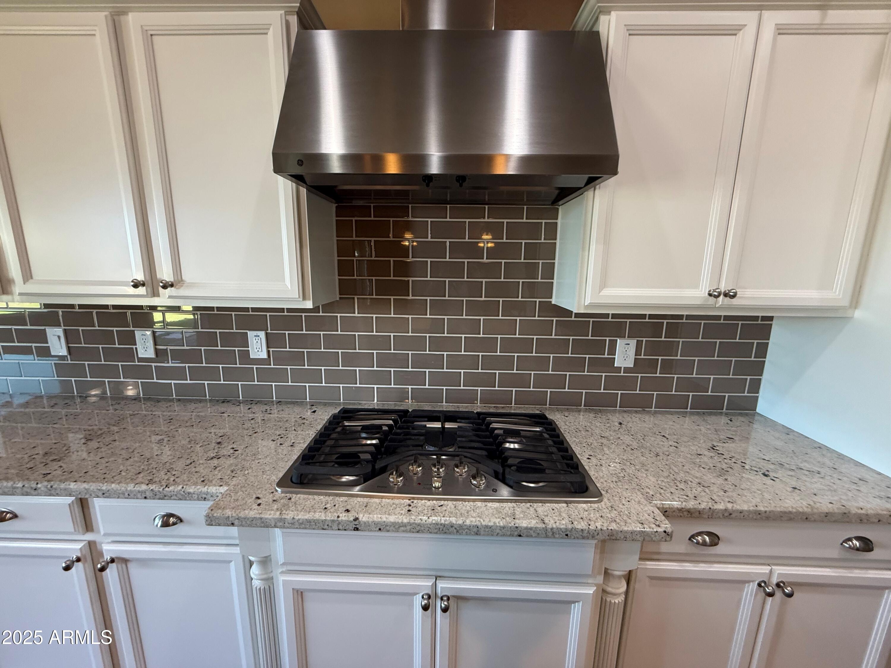2709 North Black Rock Road Buckeye, AZ 85396 - Photo 18 of 74 a stove top oven sitting inside of a kitchen