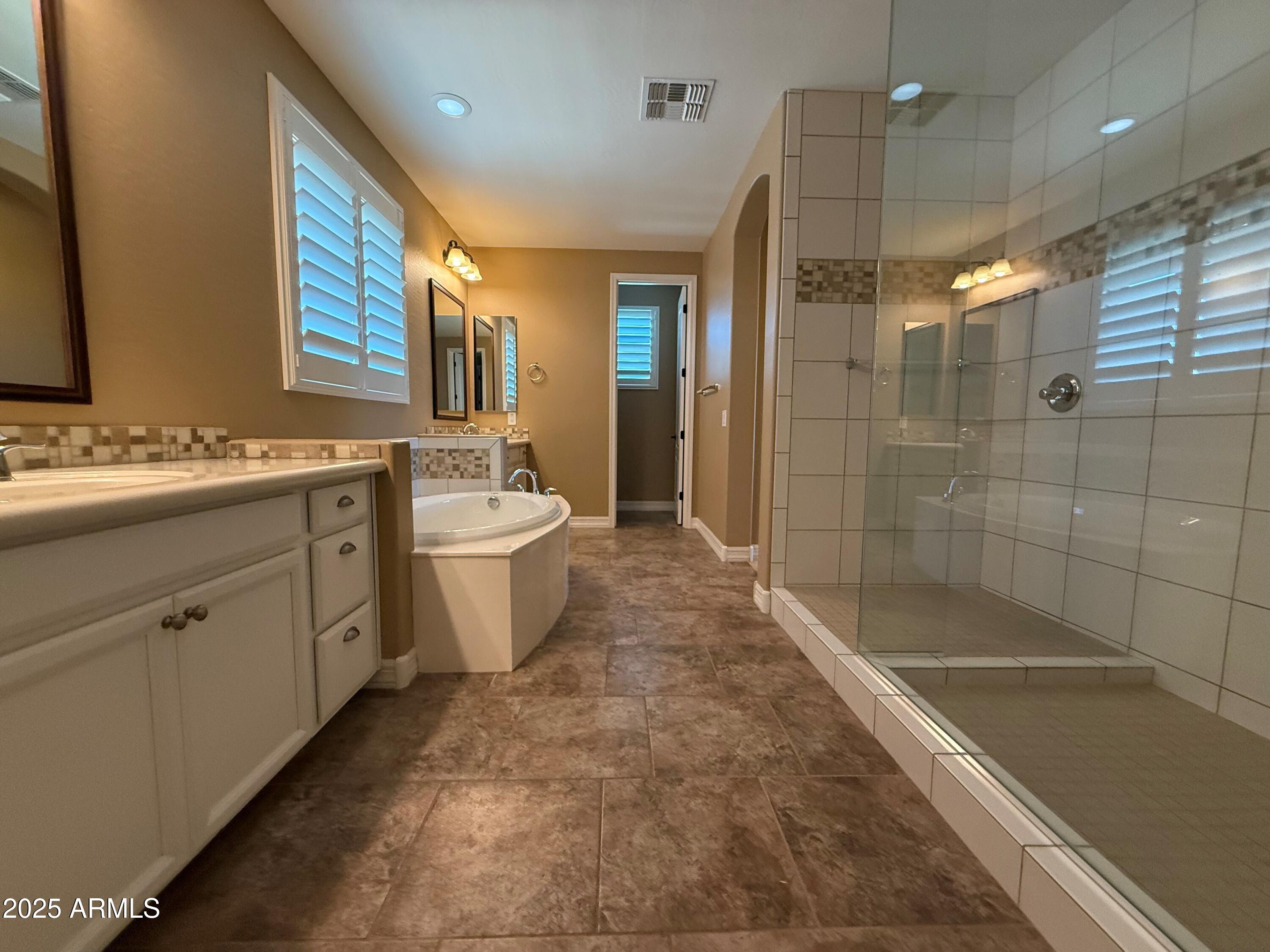 2709 North Black Rock Road Buckeye, AZ 85396 - Photo 36 of 74 a bathroom with a double vanity sink a toilet and shower