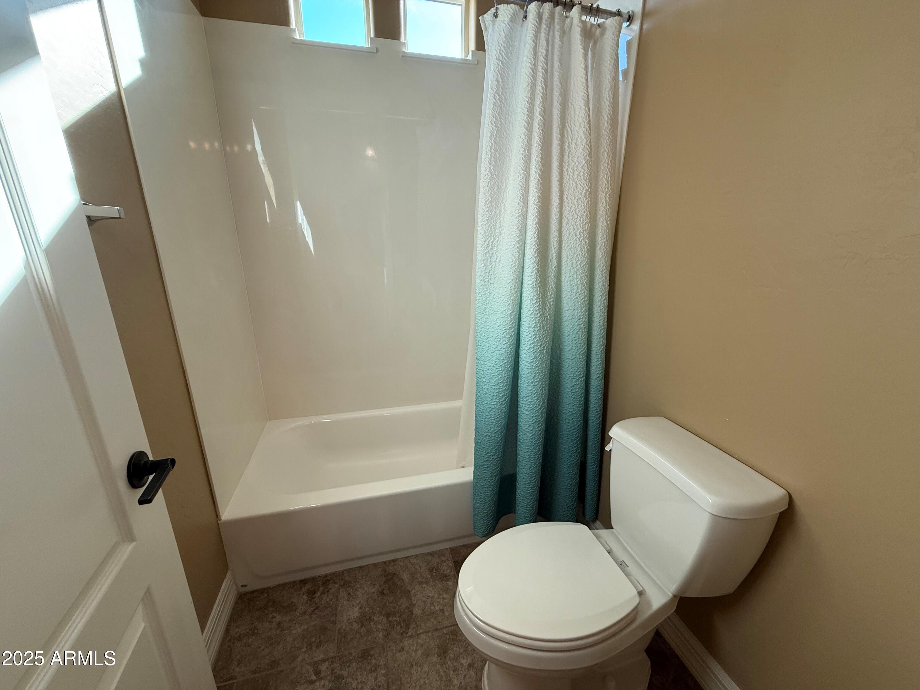 2709 North Black Rock Road Buckeye, AZ 85396 - Photo 48 of 74 a white toilet sitting next to a bath tub