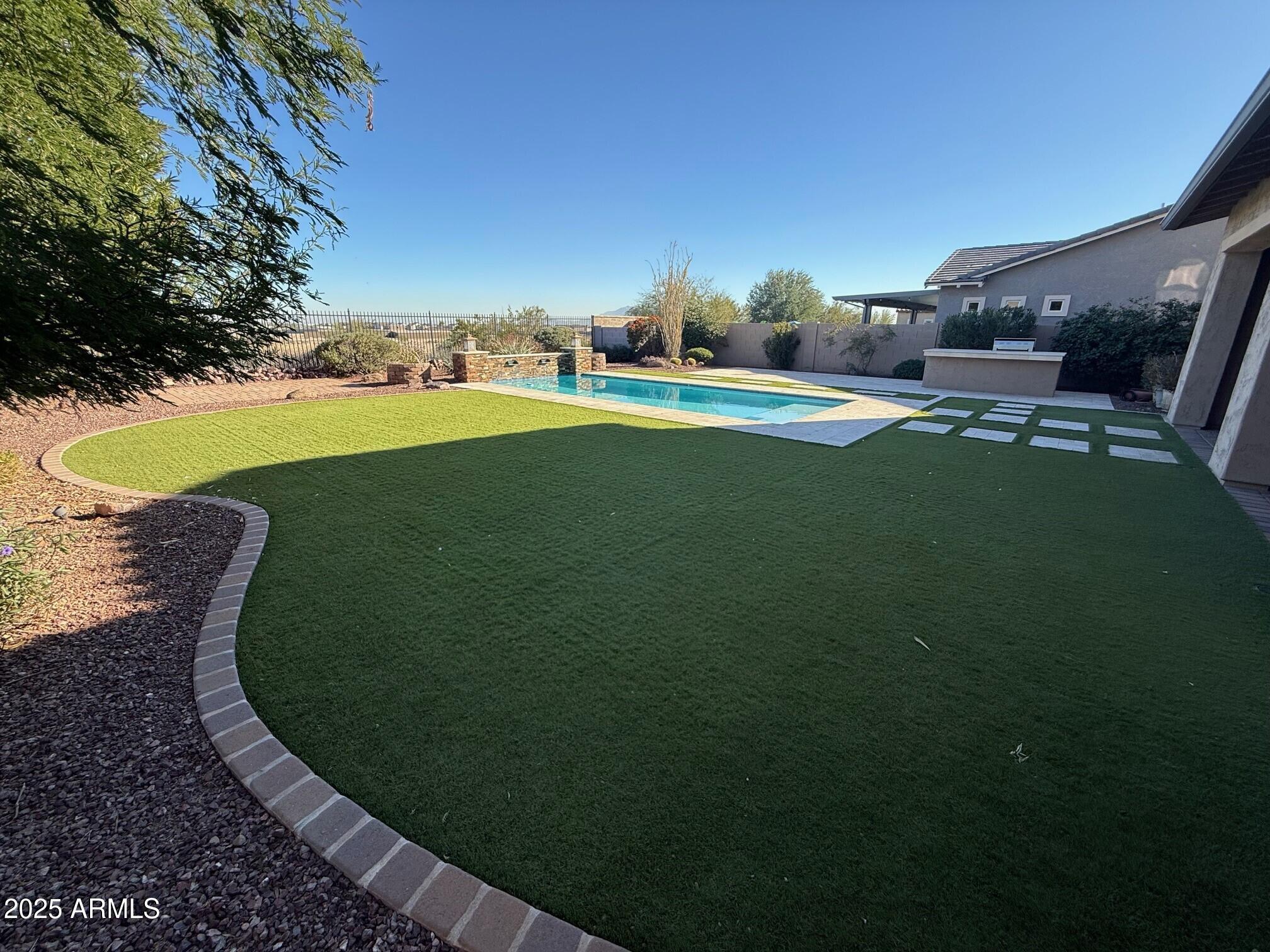 2709 North Black Rock Road Buckeye, AZ 85396 - Photo 58 of 74 a view of a golf course with a garden