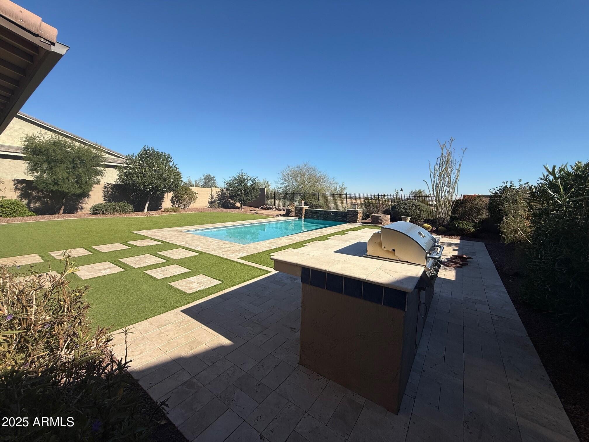 2709 North Black Rock Road Buckeye, AZ 85396 - Photo 64 of 74 a view of a patio with a table and chairs