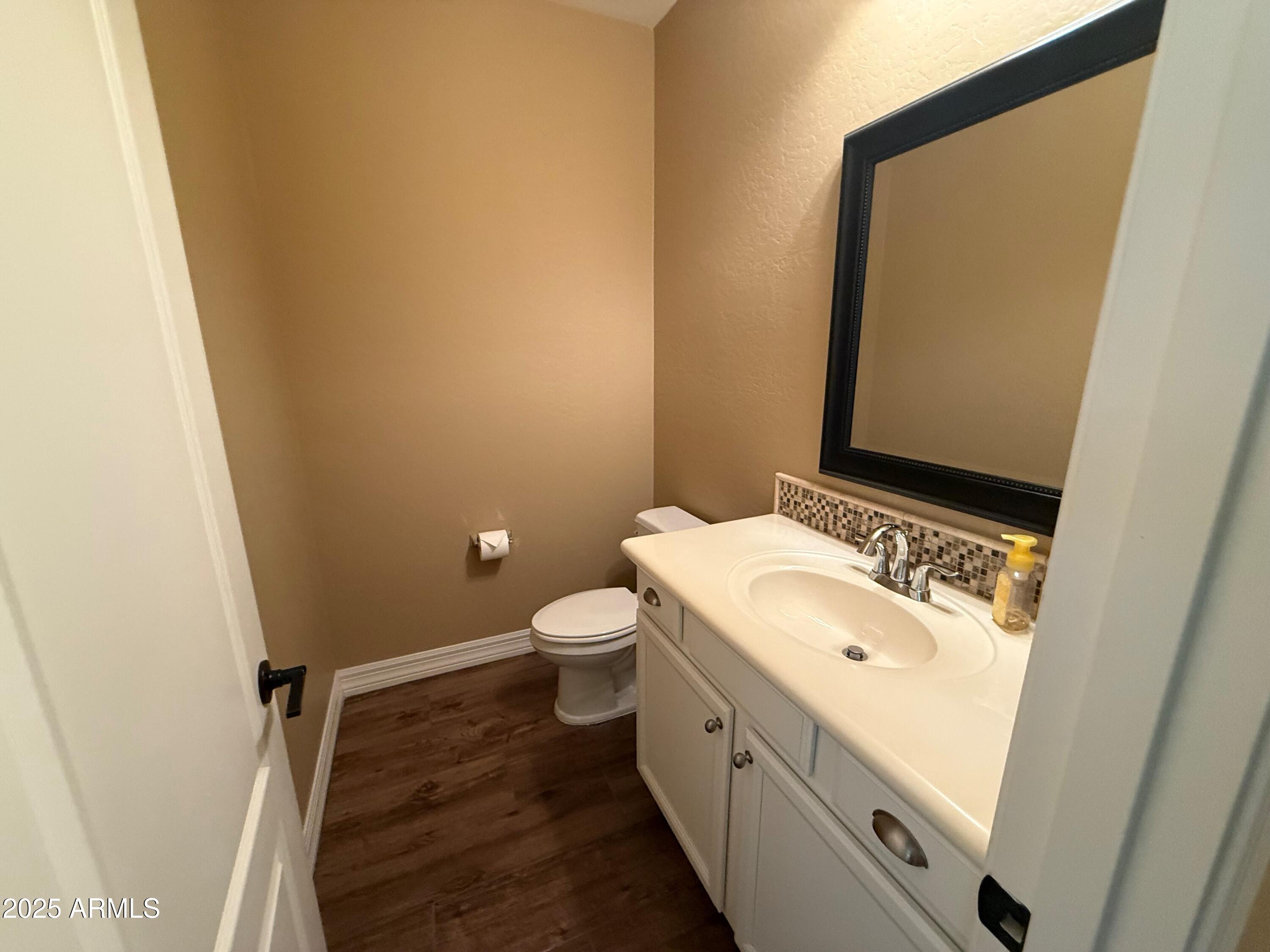 2709 North Black Rock Road Buckeye, AZ 85396 - Photo 9 of 74 a bathroom with a granite countertop sink and a mirror