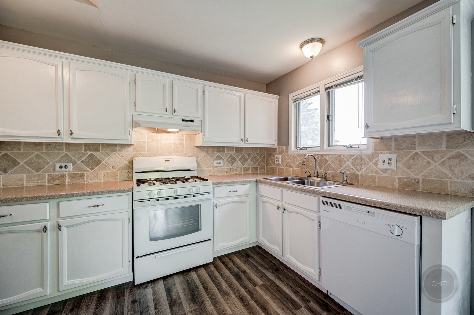 985 West Court, Unit D Naperville, IL 60563 - Photo 11 of 29 a kitchen with granite countertop white cabinets and white appliances