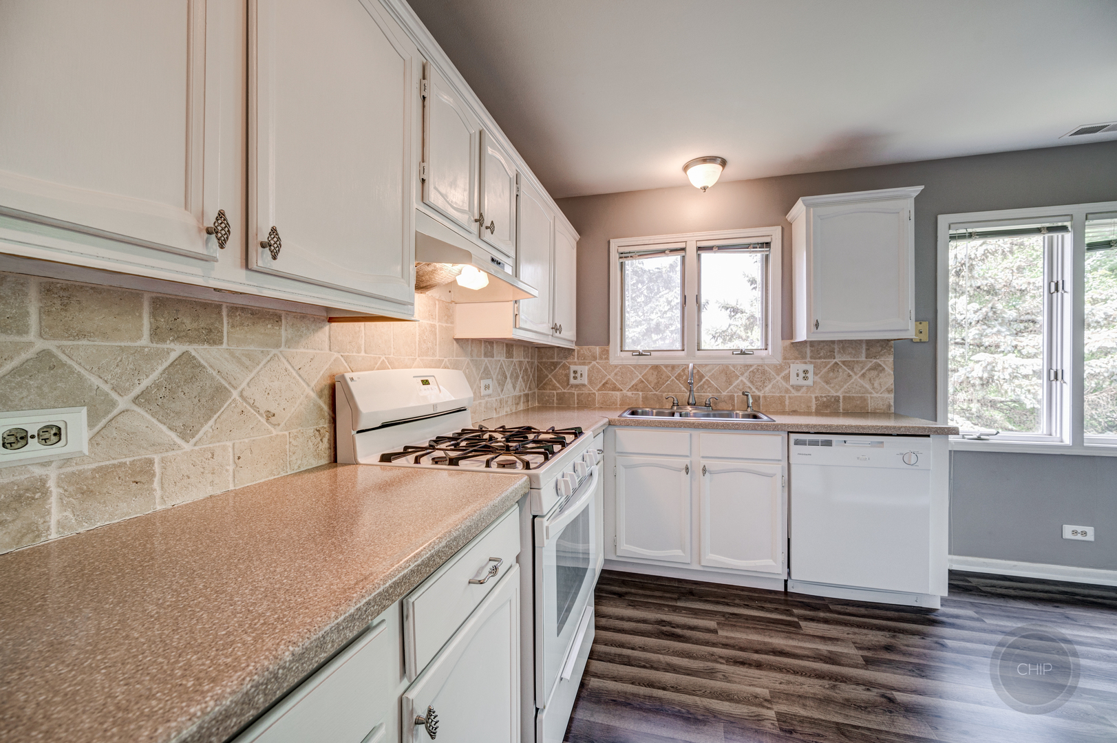 985 West Court, Unit D Naperville, IL 60563 - Photo 13 of 29 a kitchen with stainless steel appliances granite countertop a sink and a stove