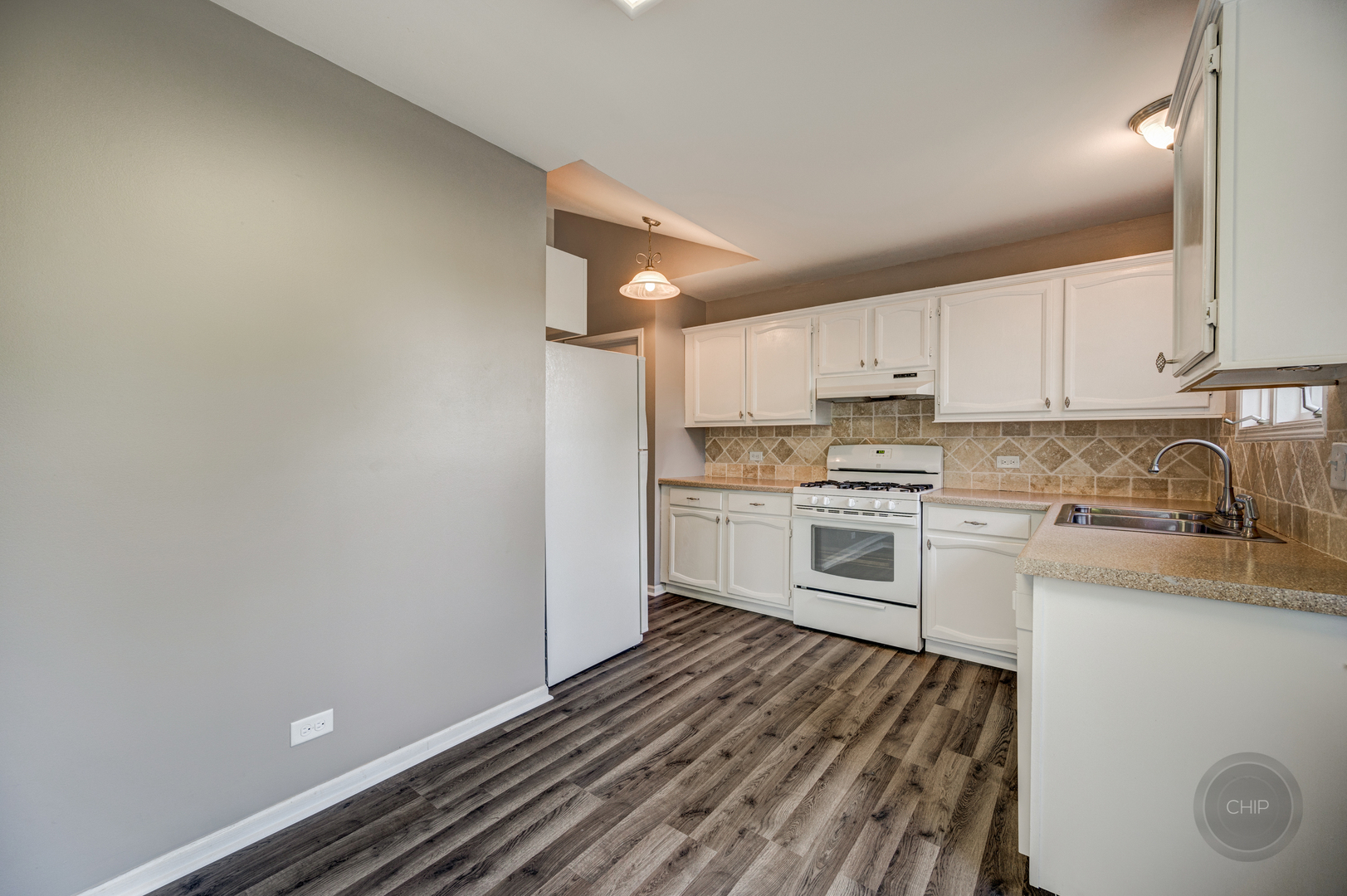 985 West Court, Unit D Naperville, IL 60563 - Photo 14 of 29 a kitchen with granite countertop white cabinets and white appliances