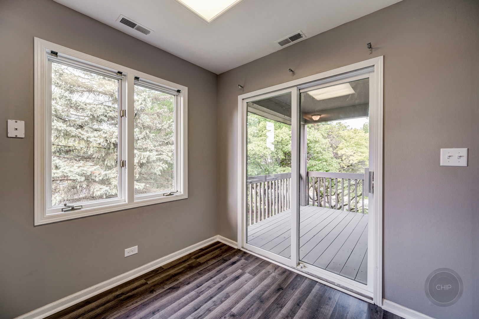 985 West Court, Unit D Naperville, IL 60563 - Photo 16 of 29 a view of an empty room with wooden floor and a window