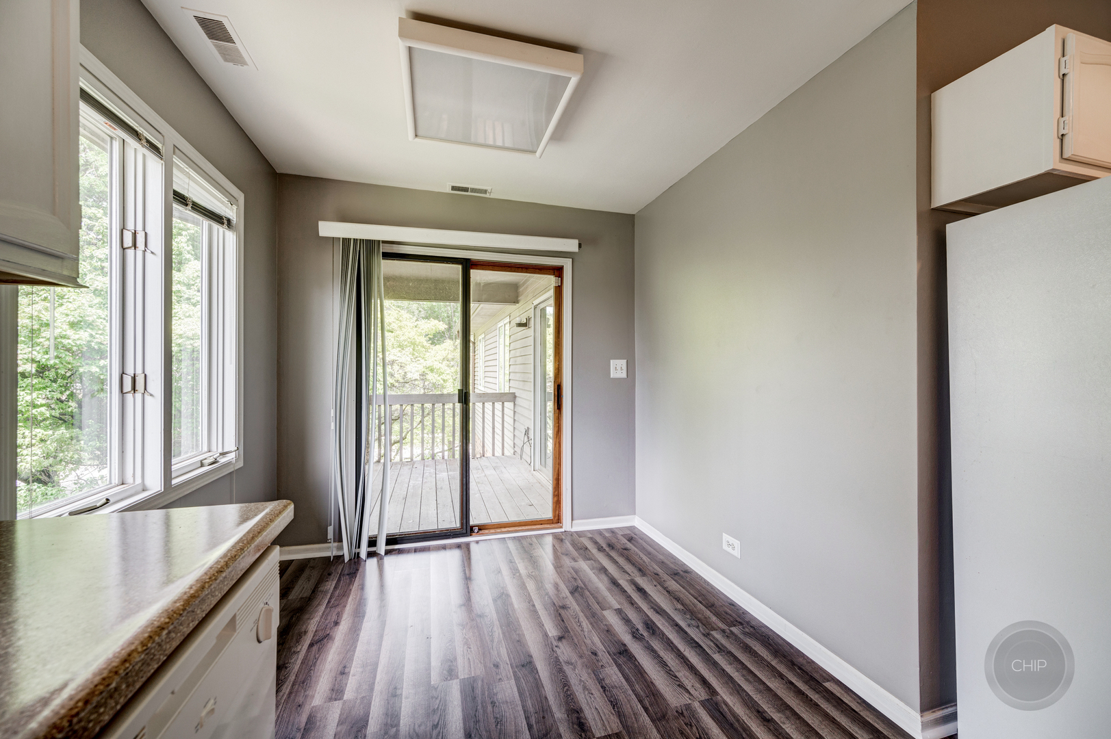 985 West Court, Unit D Naperville, IL 60563 - Photo 17 of 29 a view of hallway with a large window and wooden floor