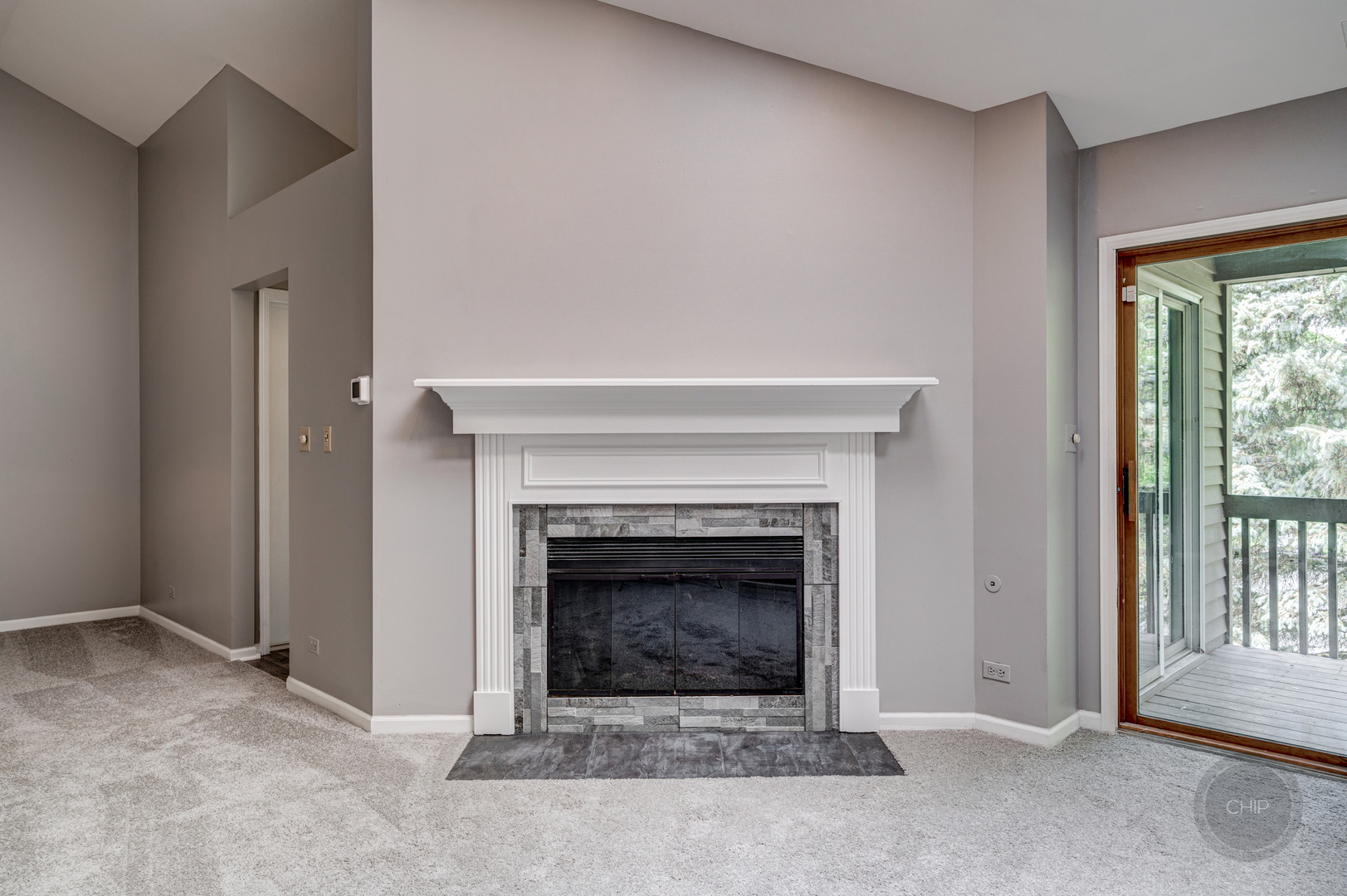 985 West Court, Unit D Naperville, IL 60563 - Photo 6 of 29 an empty room with a fireplace