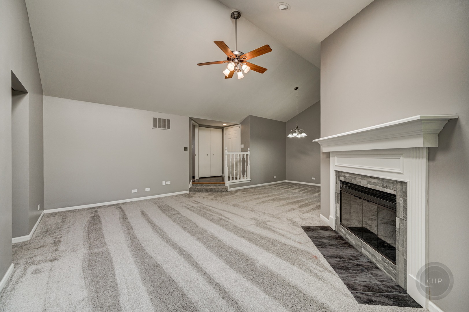 985 West Court, Unit D Naperville, IL 60563 - Photo 8 of 29 a view of a livingroom with a fireplace a ceiling fan and wooden floor