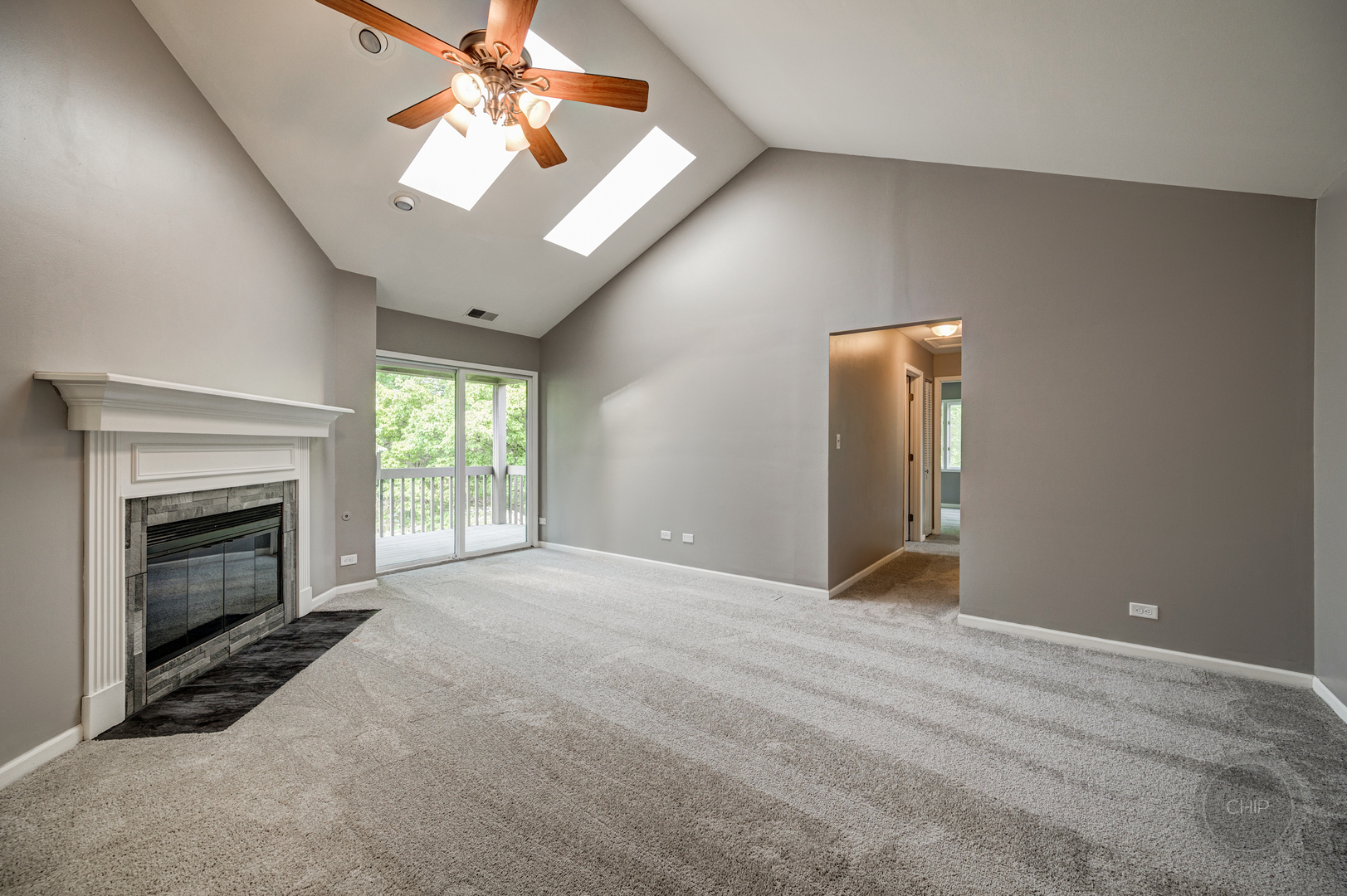 985 West Court, Unit D Naperville, IL 60563 - Photo 9 of 29 a view of empty room with fireplace and fan