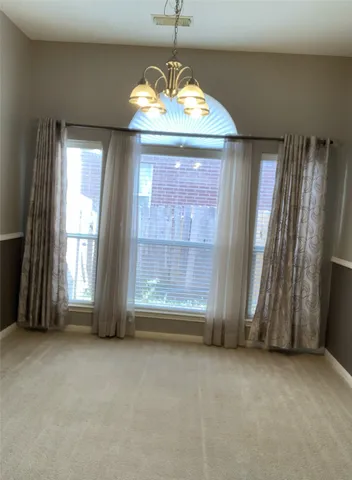 an empty room with windows and door