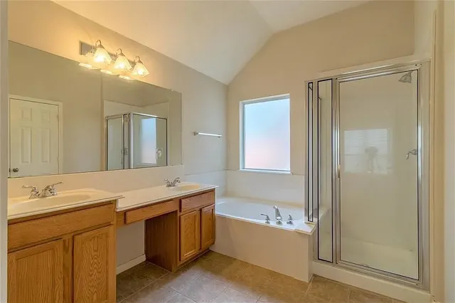 a bathroom with a tub a sink and a mirror