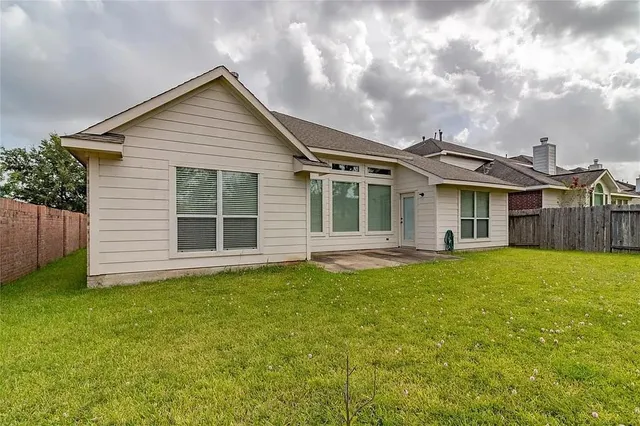 a view of a house with a yard and garage